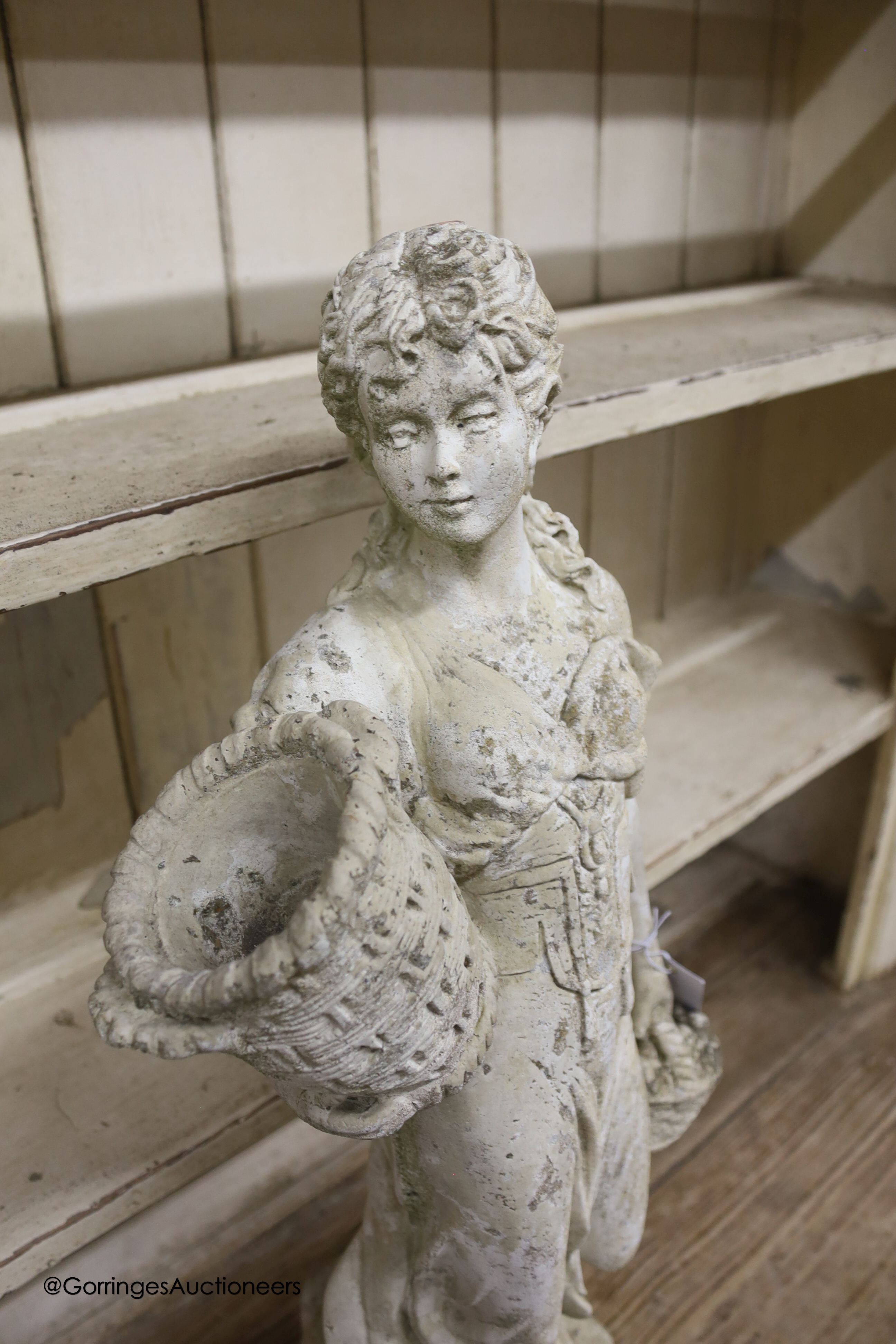 A reconstituted stone figure of a female fruit picker, height 69cm